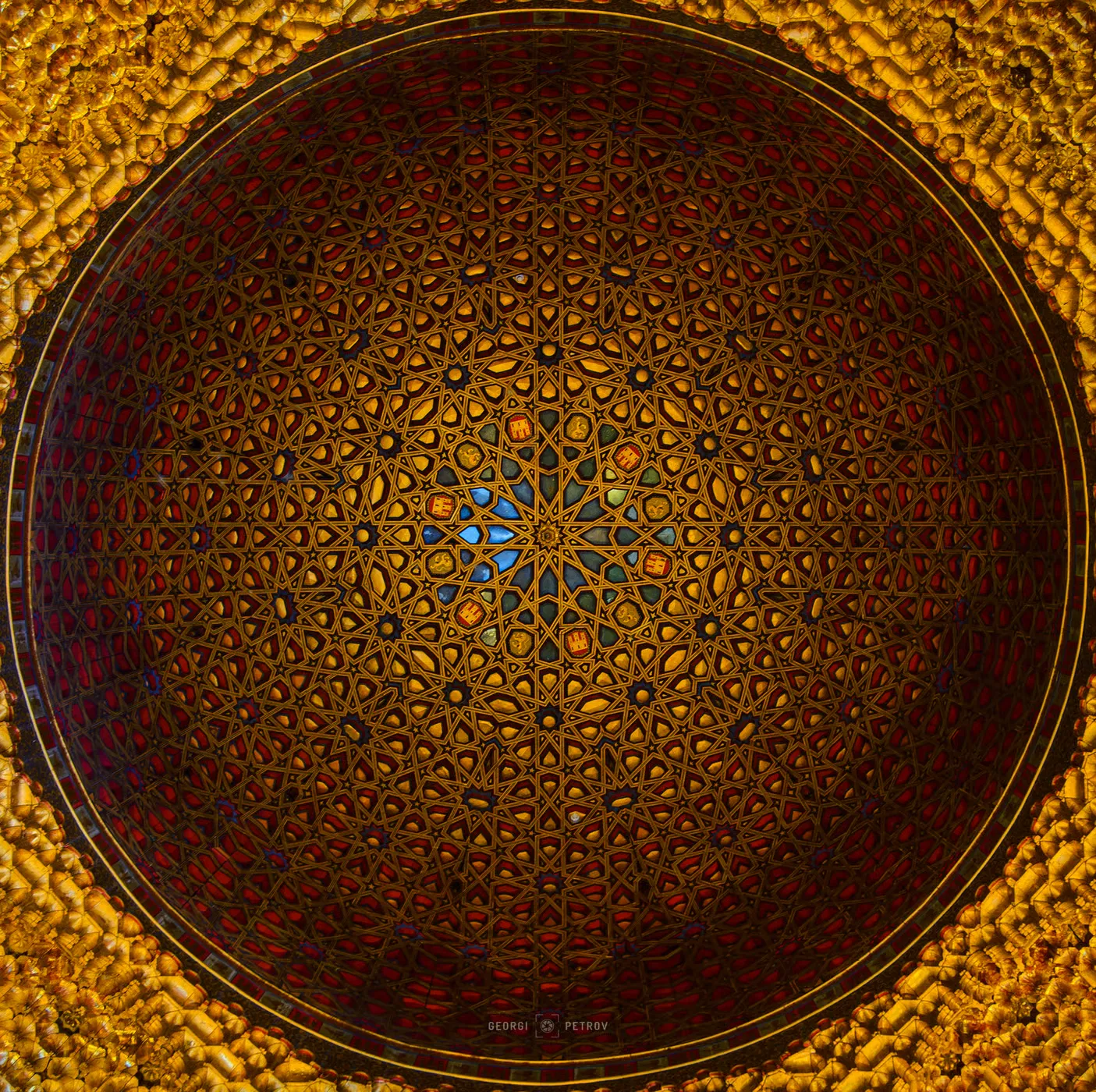 Layered geometric coffers and gold accents in royal reception hall ceiling