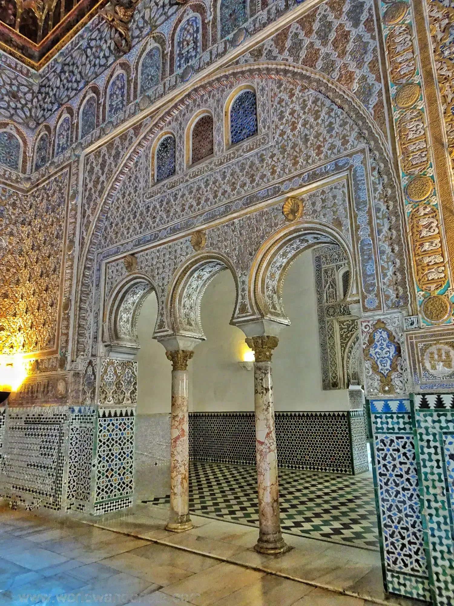 Decorated doorway with carved stucco, tiles and wooden lattice panels