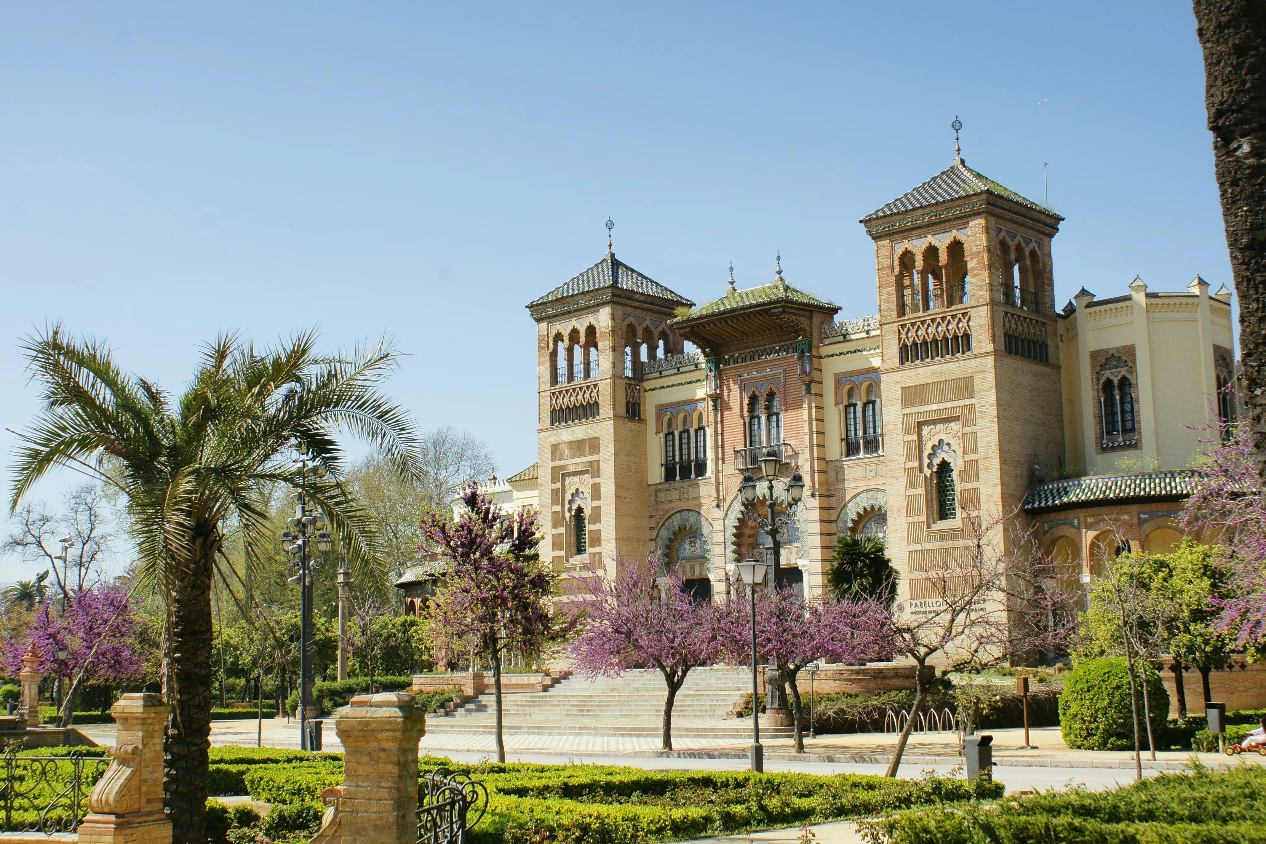 Mixed plantings and palm canopy creating layered Alcázar garden biodiversity